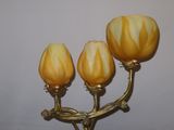 three lights that are on a gold colored stand