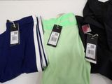 three pairs of men ' s pants with tags on them on a table