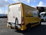 a yellow van that is parked in a parking lot