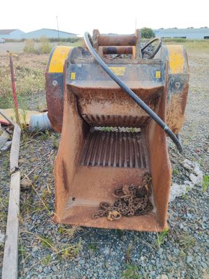 a bulldozer that is sitting on the gravel