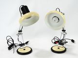 pair of yellow and black lamps on a white surface