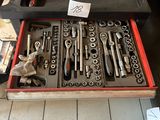 many tools in a tool box on the floor