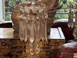 a glass candle holder sitting on a table next to a box