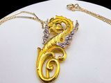 yellow and white gold plated necklace on a white plate