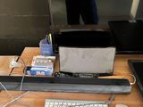 a desk with a computer, keyboard, mouse, and other items on it