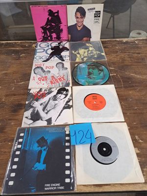 a lot of records sitting on a table in front of a window
