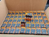 a cardboard box filled with lots of orange and blue candy