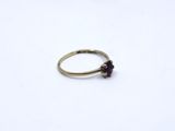 a close up of a gold ring with a flower on it