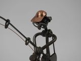 a metal sculpture of a man holding a fishing rod