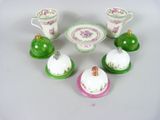 a small group of miniature dishes and cups on a table