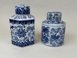 pair of blue and white vases with birds and flowers on them