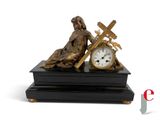 a statue of a woman holding a cross and a clock