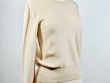 a mannequin mannequin wearing a beige sweater and shorts