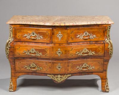 a marble top chest of drawers on display in a room