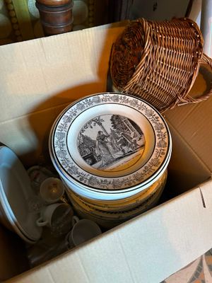 a box full of plates and bowls sitting on the floor