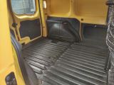 a yellow van with the door open and the floor covered in plastic
