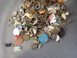 a pile of assorted key chains on a table