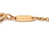 a close up of a gold keychain with a chain attached to it