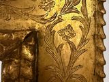 a gold plate with a floral design on it