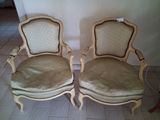 two chairs sitting next to each other on a tiled floor