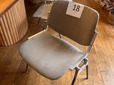 a lot of chairs that are sitting in front of a table