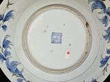 a blue and white plate with blue flowers on it