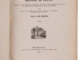 an open book with a picture of a castle in the background