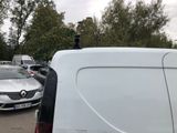 a white van parked in a parking lot with other cars in the background