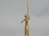 a gold figurine of a man holding a baseball bat