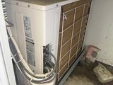 a air conditioner sitting in a garage next to a door