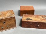 three small wooden boxes with birds painted on them sitting on a table