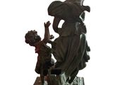 a statue of a woman and a child on a bench