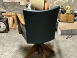 a black chair with a book on it in a room
