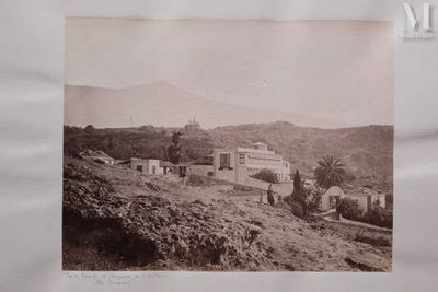a picture of an old picture of a house on a hill