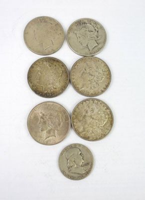 six different types of coins on a white surface