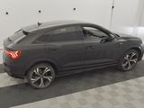an image of a black car parked in a garage