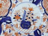 a blue and orange plate with flowers on it