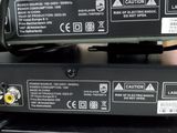two remote controls on top of each other on a table
