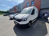 a white van parked in front of a building