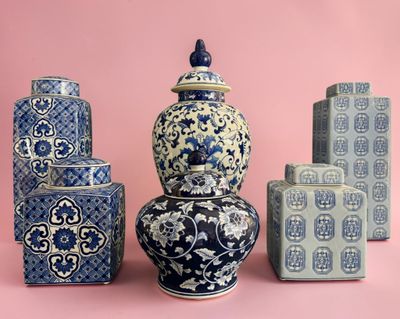 four blue and white vases sitting next to each other