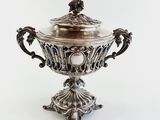 an antique silver plated bowl with a lid on a stand