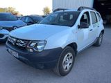 the white dacia is parked in a lot with other cars