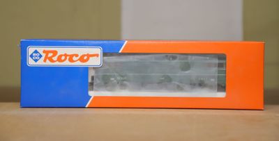an orange and blue box sitting on top of a table next to a white wall