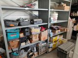 many boxes and tools on the shelves in the garage