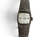 an image of a close up of a wrist watch on a white surface