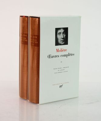 two books sitting on top of a white table next to each other