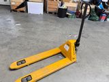a fork lifter sitting on the floor in a warehouse