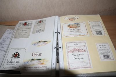 un livre ouvert, sur lequel sont collées des étiquettes, posé sur une table