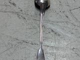 a spoon and a spoon rest on a table
