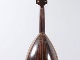 a small musical instrument on a stand on a white surface